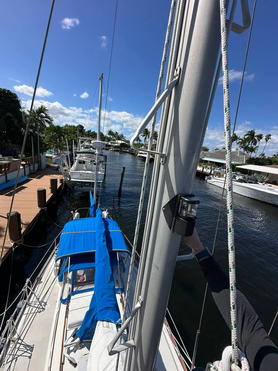 Hands-on work on a sailboat mast light in a South Florida marina.